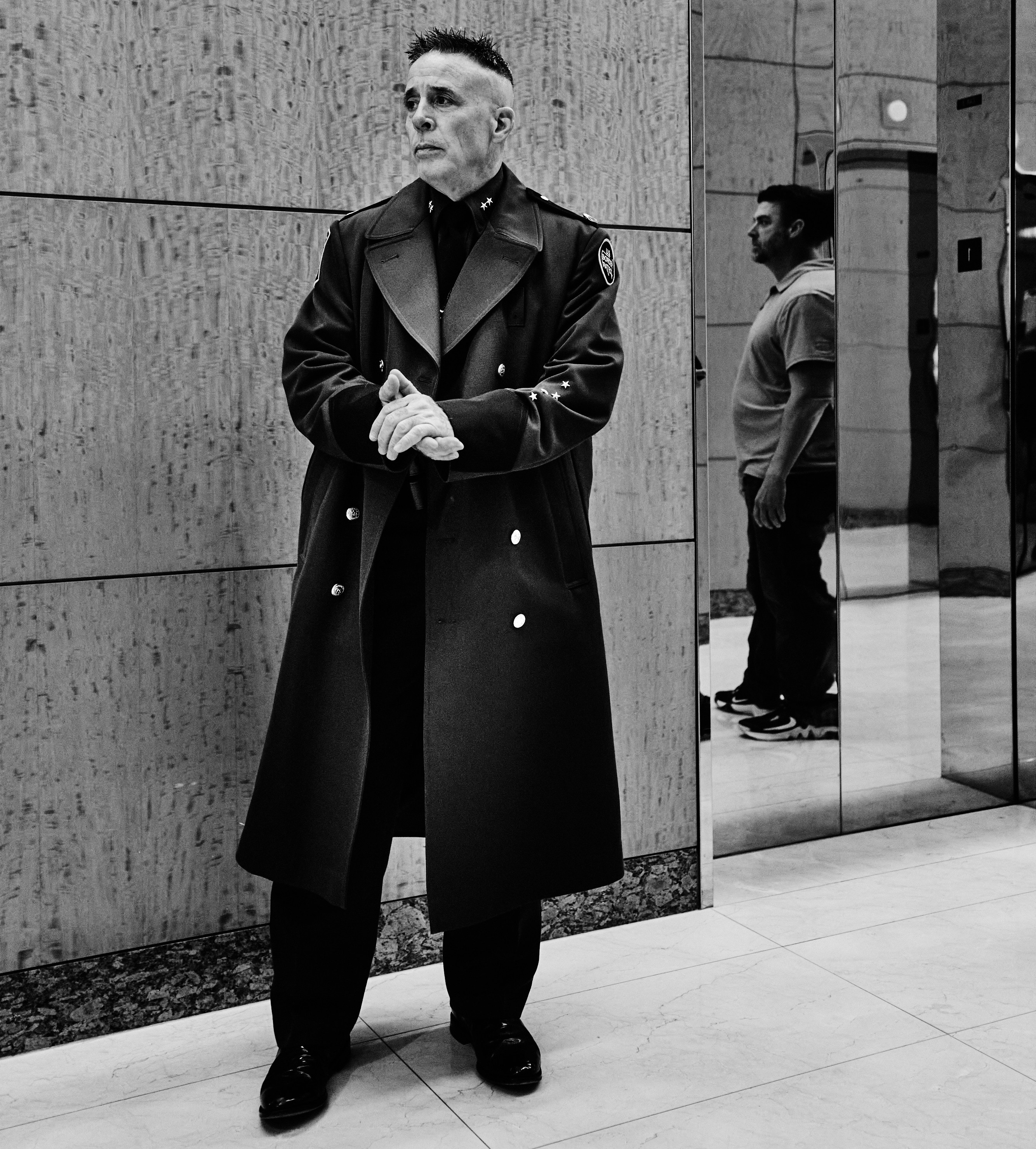 US Border Patrol Chief Greg Bovino waits in a lobby before an interview.