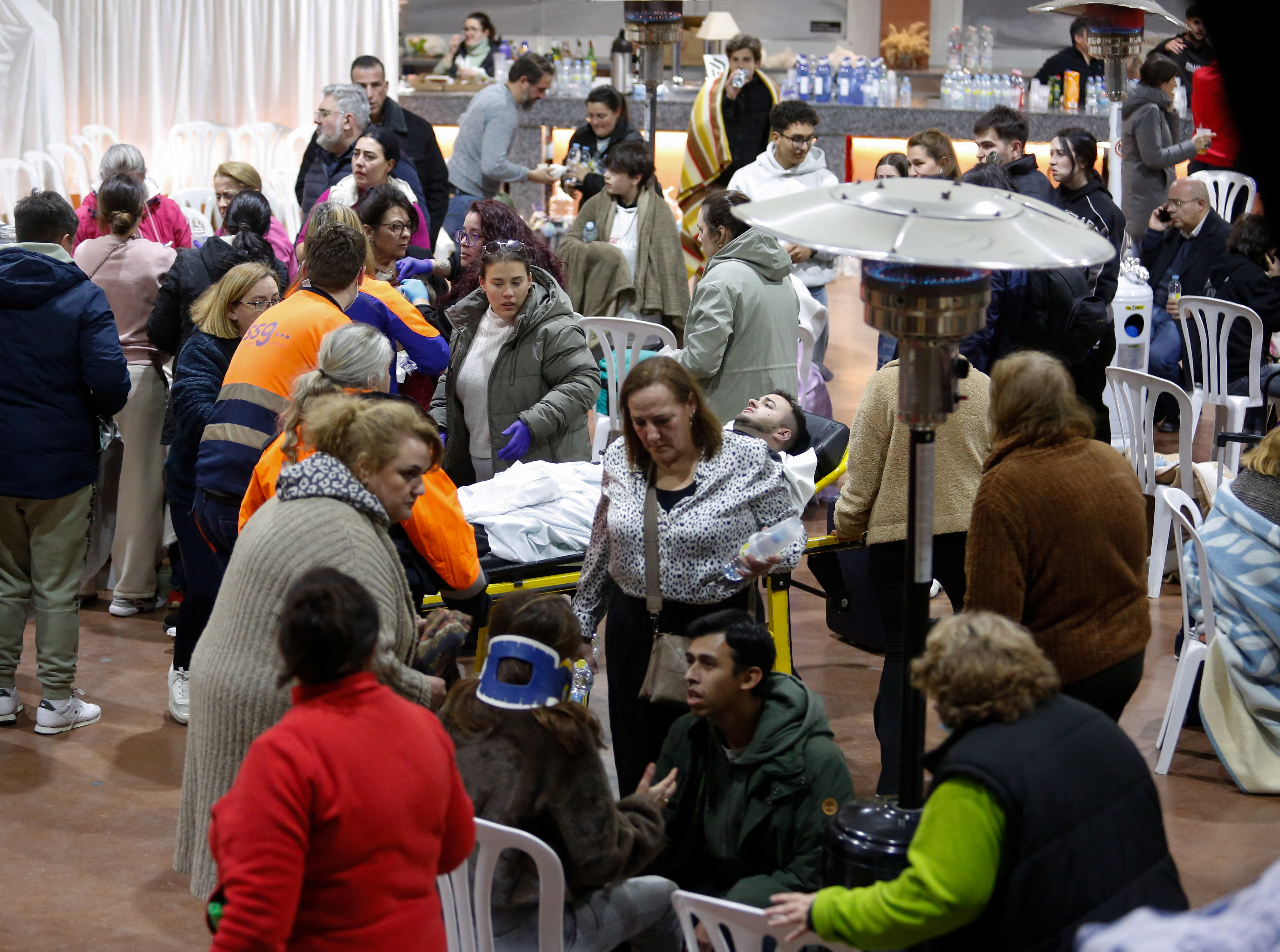 People affected by a deadly train derailment are transferred and treated at the Caseta Municipal in the town of Adamuz.
