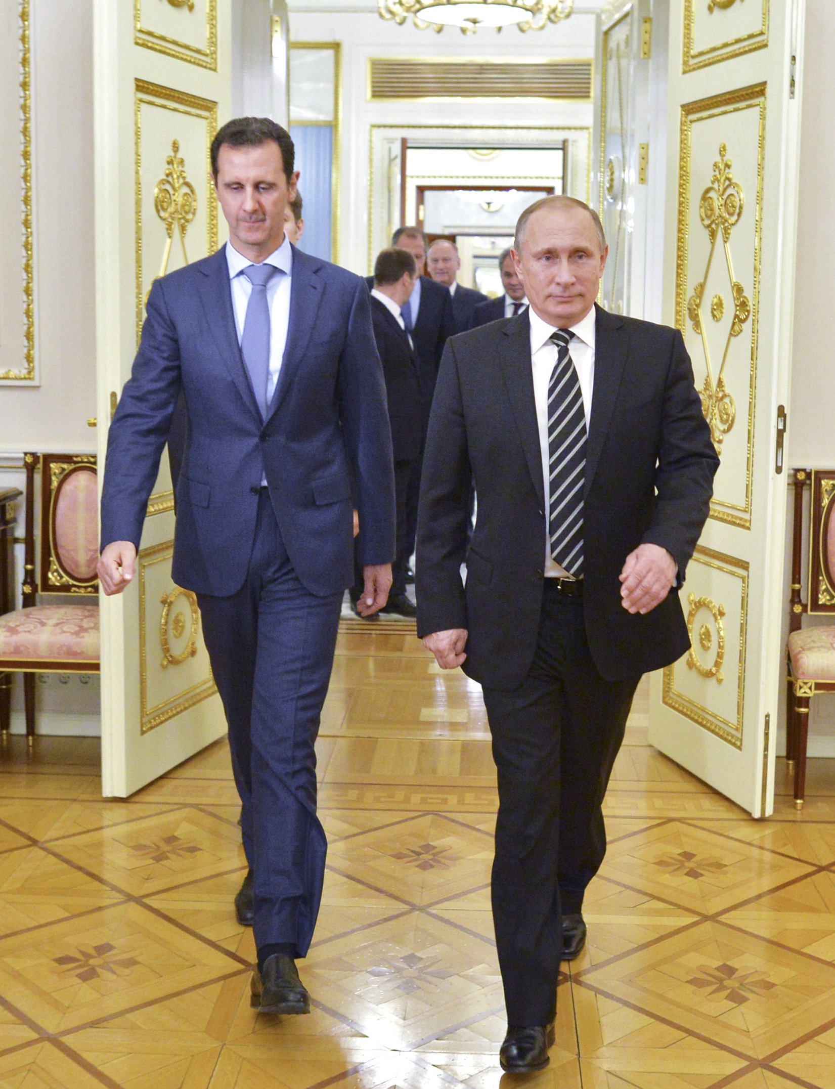 Russian President Vladimir Putin and Syrian President Bashar al-Assad enter a hall during a meeting at the Kremlin.