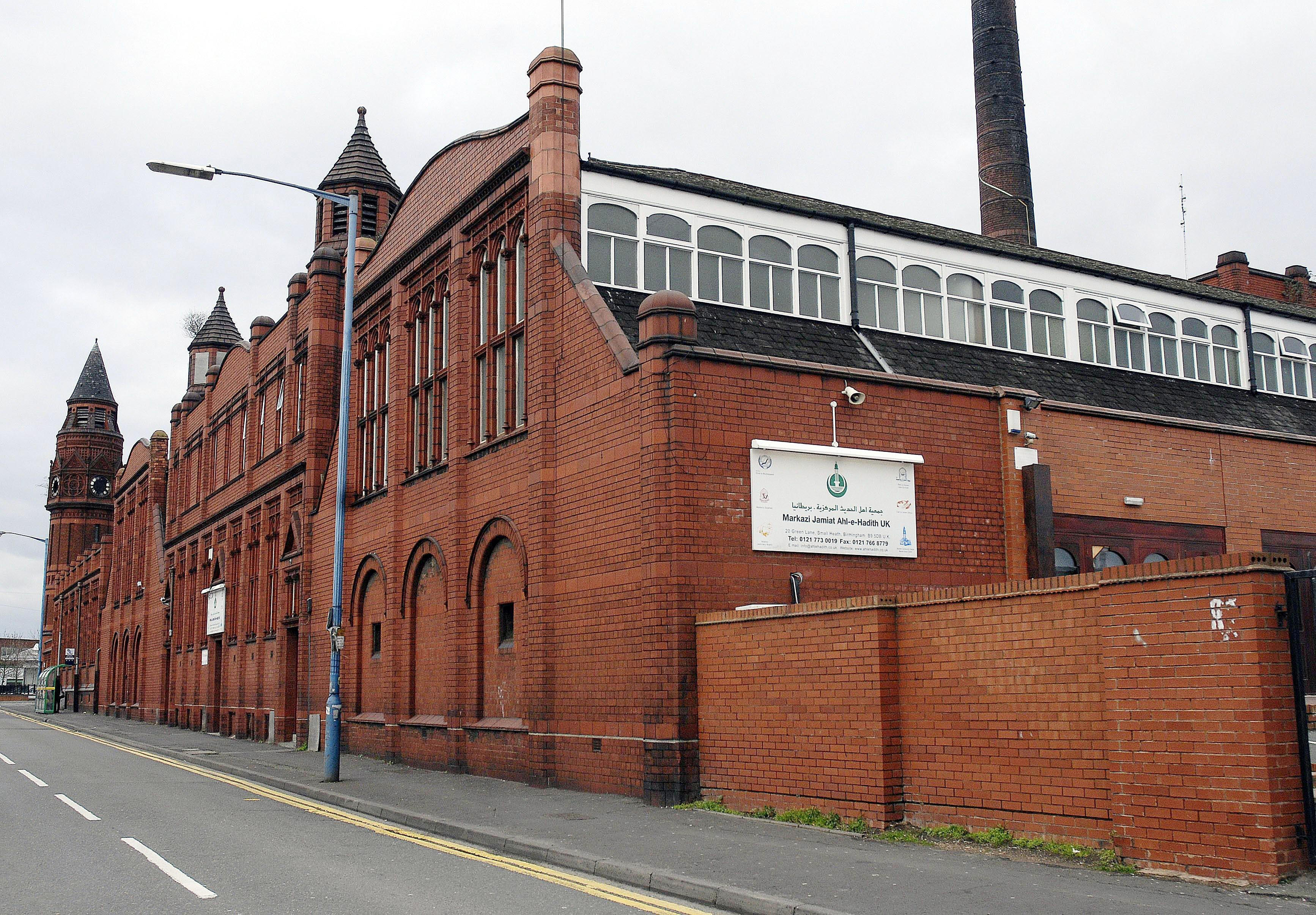 A large brick building with a sign that reads "Markazi Jamiat Ahl-e-Hadith UK" on the side, indicating a mosque in Birmingham.