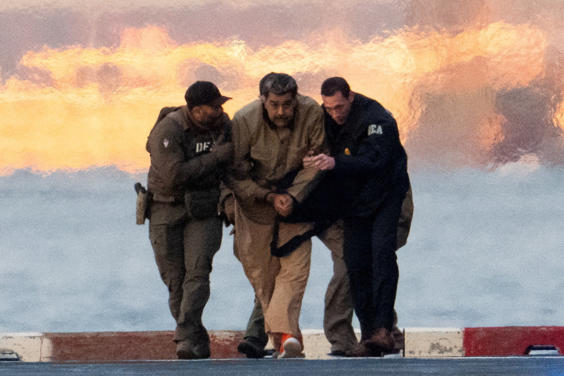 Venezuelan President Nicolas Maduro is escorted by law enforcement officials.