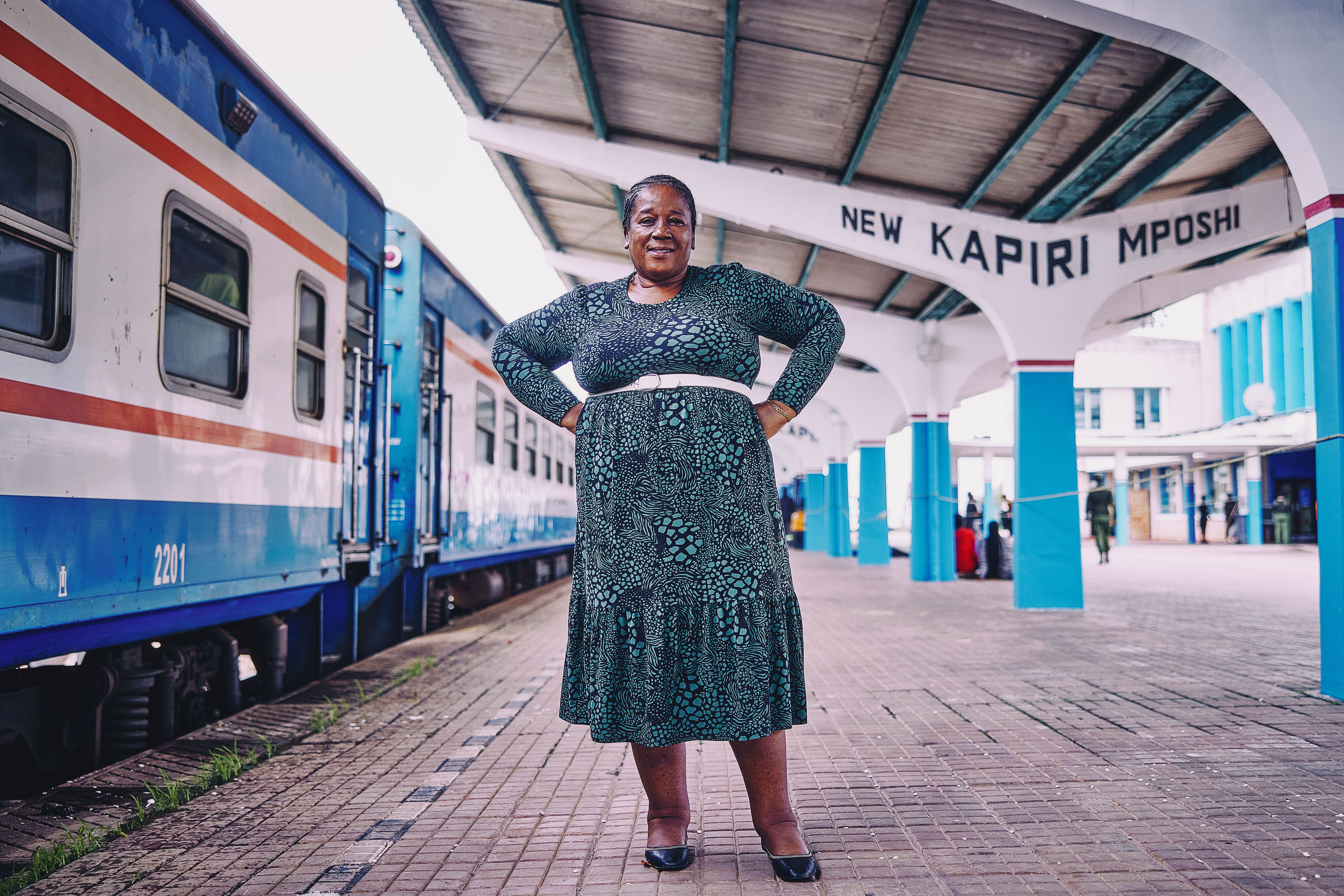Mukololo Chanda, a 59-year-old woman and station master, stands on the platform of Kapiri Mposhi Railway Station in Zambia.
