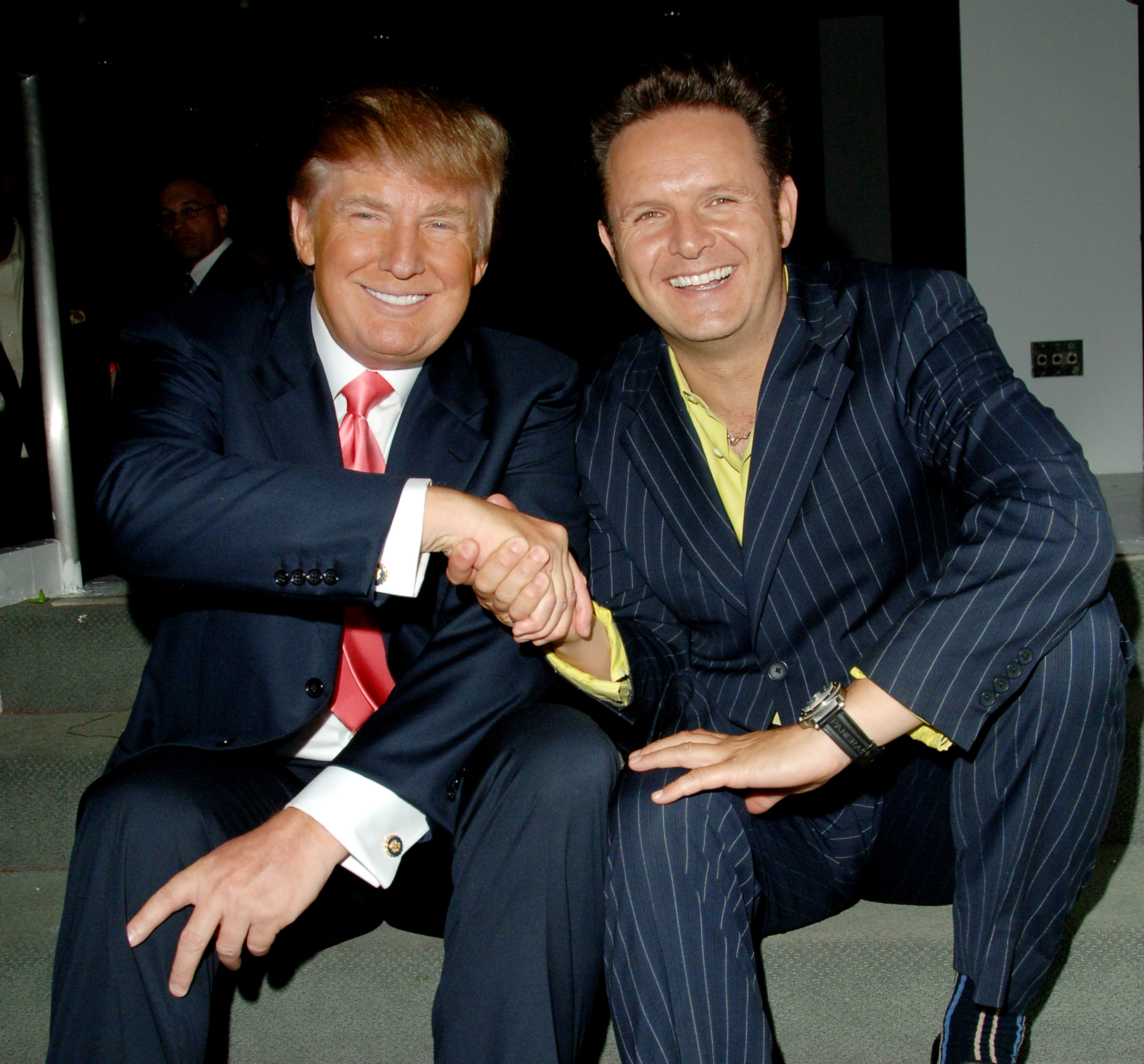 Donald Trump and Mark Burnett shaking hands at "The Apprentice" finale event.