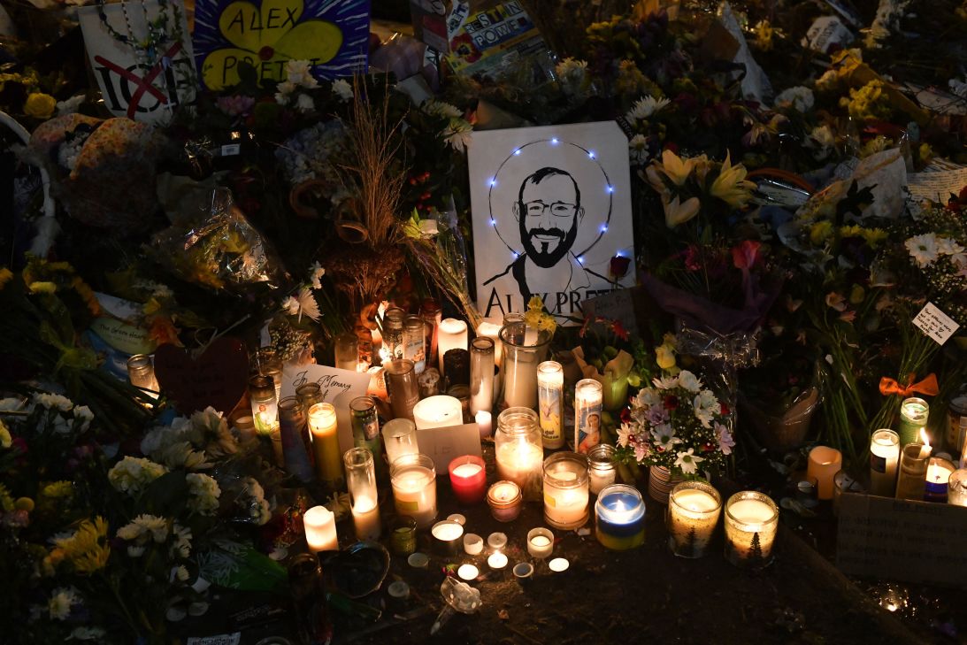 A drawing depicting 37-year-old ICU nurse Alex Pretti is displayed alongside candles at a makeshift memorial in his honor on January 26 in the area where he was shot dead by federal immigration agents in Minneapolis.