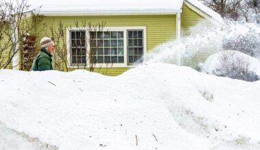 People walk from Government Center MBTA station during Boston's first major snowstorm of 2026. (Robin Lubbock/WBUR)