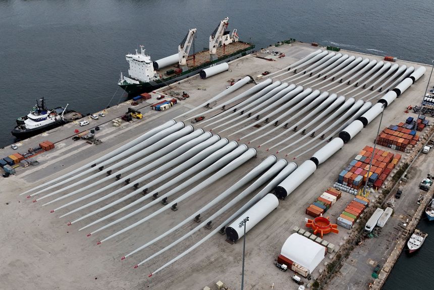A drone view shows rotor blades and other parts for the ongoing construction of the Revolution Wind offshore wind turbine farm, staged on the State Pier in New London, Connecticut, on September 23, 2025.