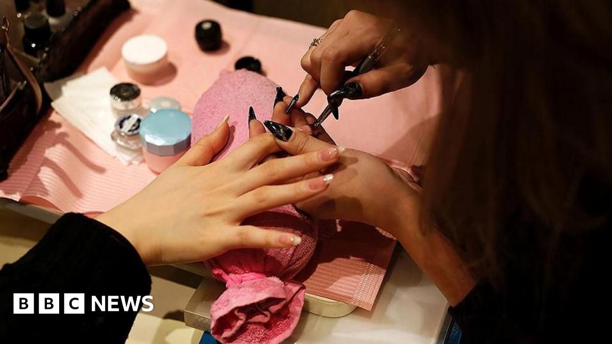 An image of someone having the nails on one of their hands manicured.