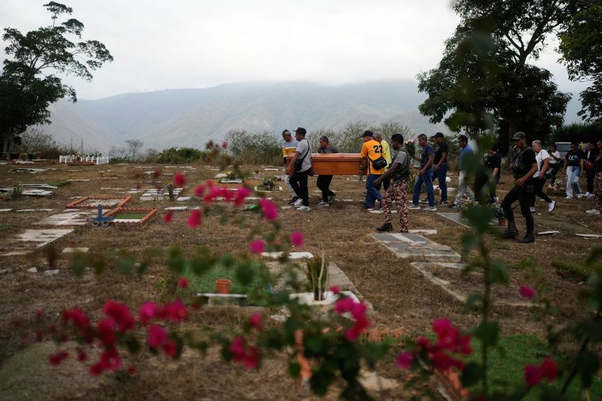 Relatives carry the coffin of Rosa Elena Gonzalez, 80, at the cemetery in La Guaira, Venezuela, on Monday. Gonzalez died after her apartment was hit during a US strike to capture President Nicolas Maduro.