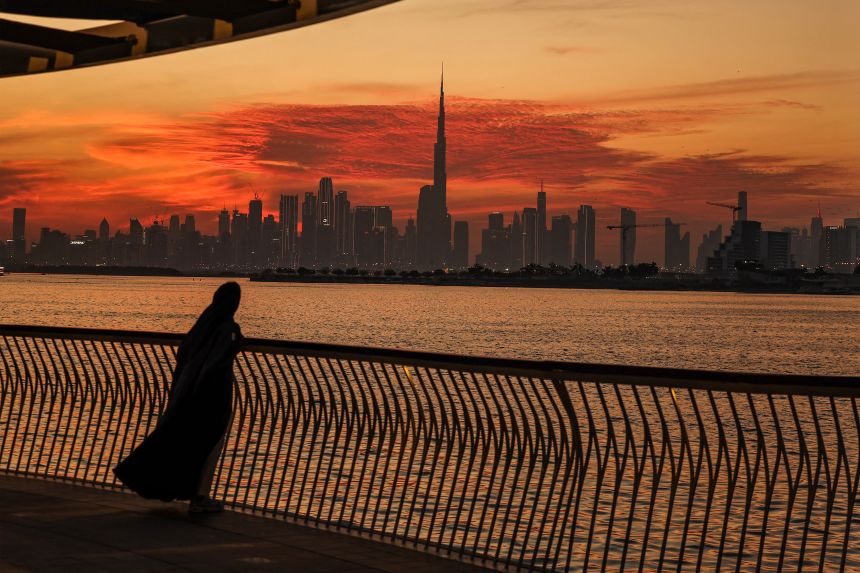 A woman looks on from Creek Harbour at the Dubai skyline with Burj Khalifa, the world's largest building (C) on February 5.
