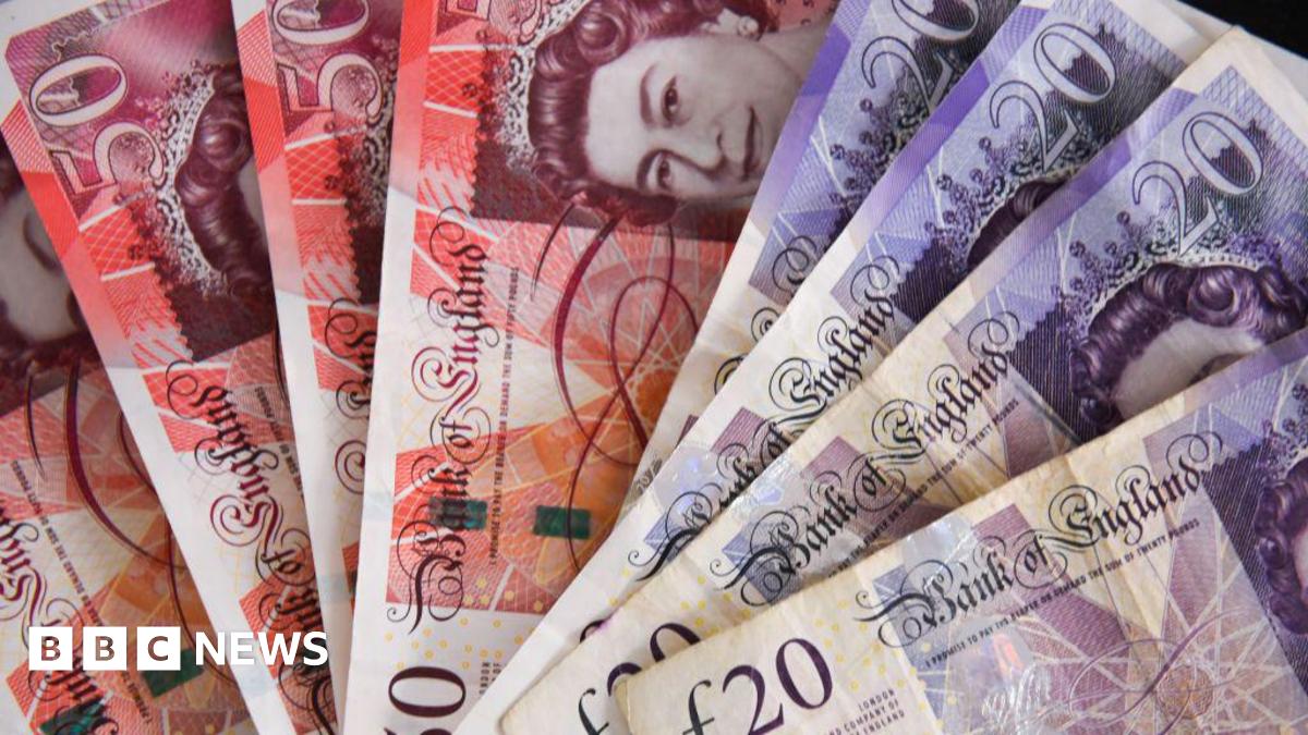 A stack of £50 and £20 bank notes spread in a fan shape