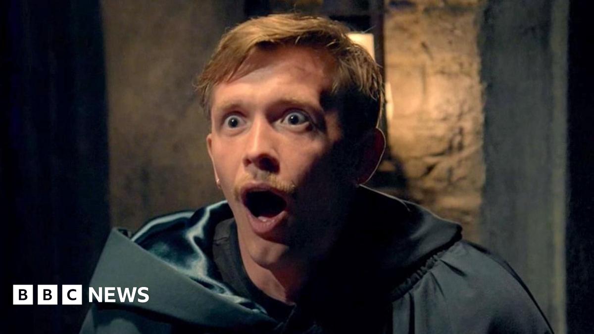 Fiona in her read cloak laughing wildly in the turret after being revealed as the secret traitor