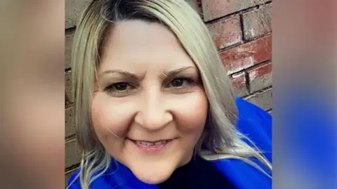 Police handout A smiling woman looking at the camera.