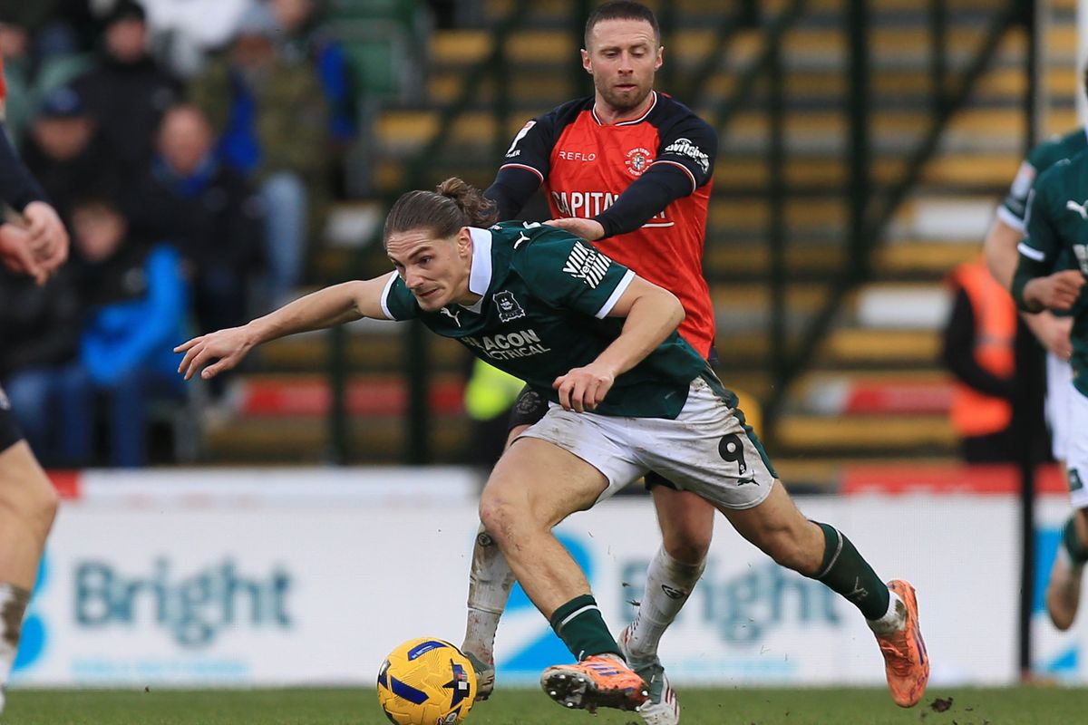Argyle striker Lorent Tolaj holds off Luton Town's Jordan Clark during the League One game at Home Park on January 24, 2026 - Photo: Dave Rowntree/PPAUK
