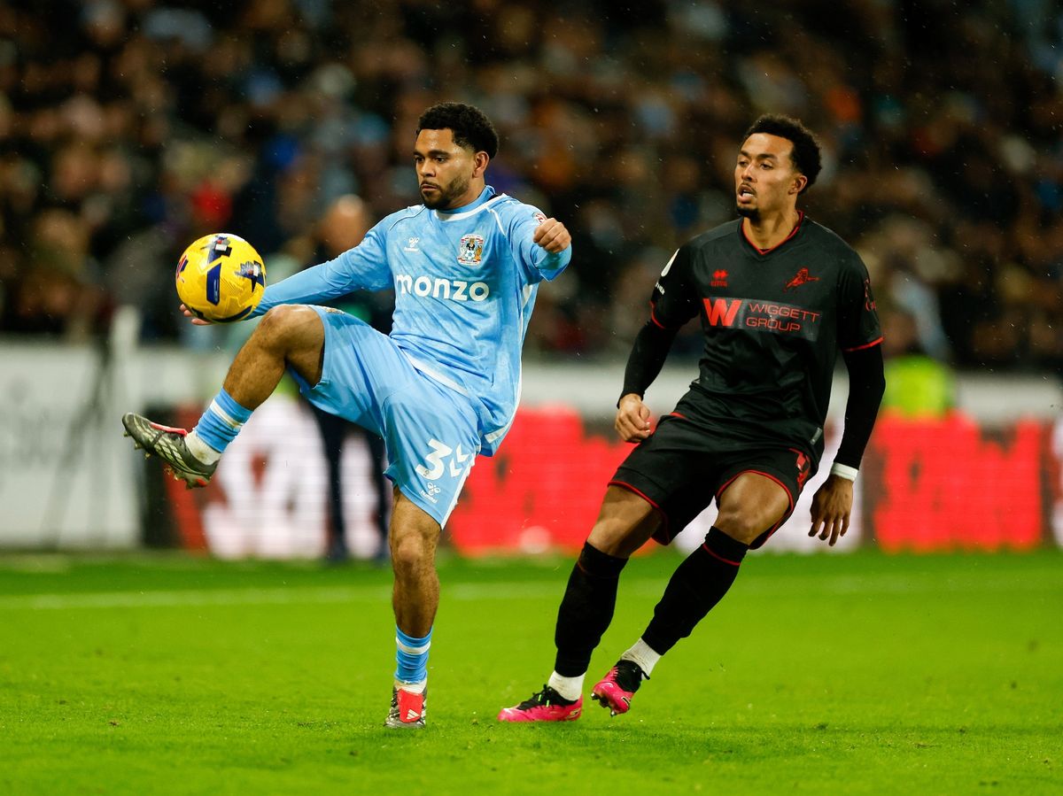 Jay Dasilva of Coventry City and Femi Azeez of Millwall compete for the ball