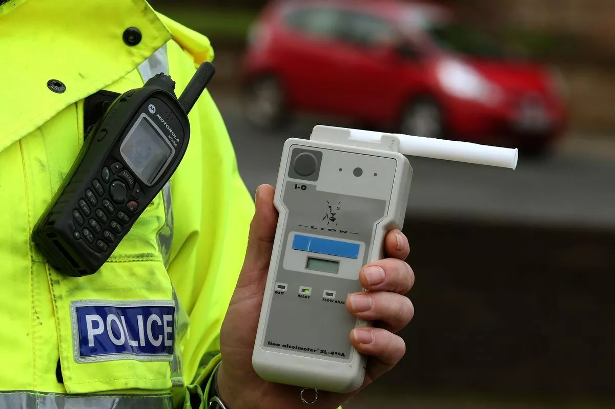 Road Traffic constable holding a breathalyser