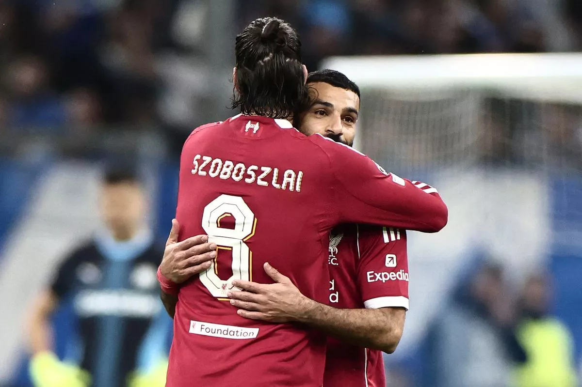 Liverpool's Hungarian midfielder #08 Dominik Szoboszlai (L) and Liverpool's Egyptian forward #11 Mohamed Salah embrace at the end of the UEFA Champions League, league phase day 7, football match between Olympique de Marseille (OM) and Liverpool FC at the Stade Velodrome in Marseille, southern France, on January 21, 2026. (Photo by Thibaud MORITZ / AFP via Getty Images)