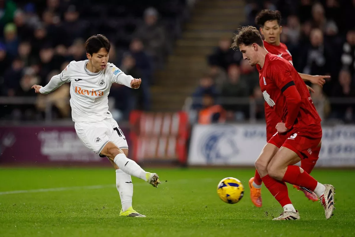 Birmingham City defender Phil Neumann closes down Swansea's Eom Ji-Sung 