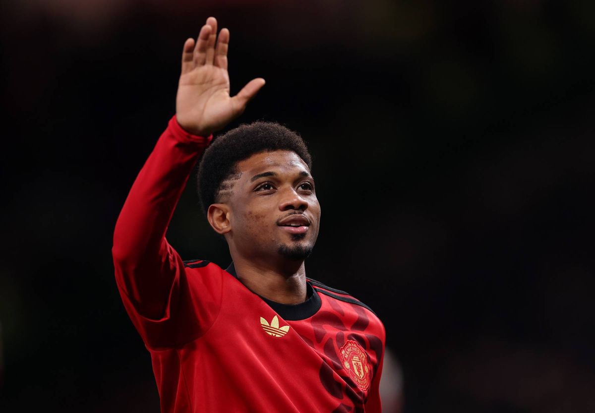 Manchester United winger Amad holds up his hand