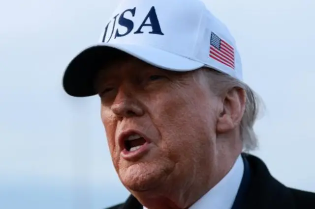 Donald Trump in a white USA cap