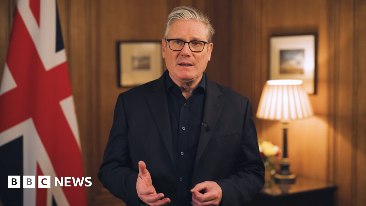 Sir Keir Starmer reads his new year's message, standing in a wood-panelled room in front of a Union Jack.