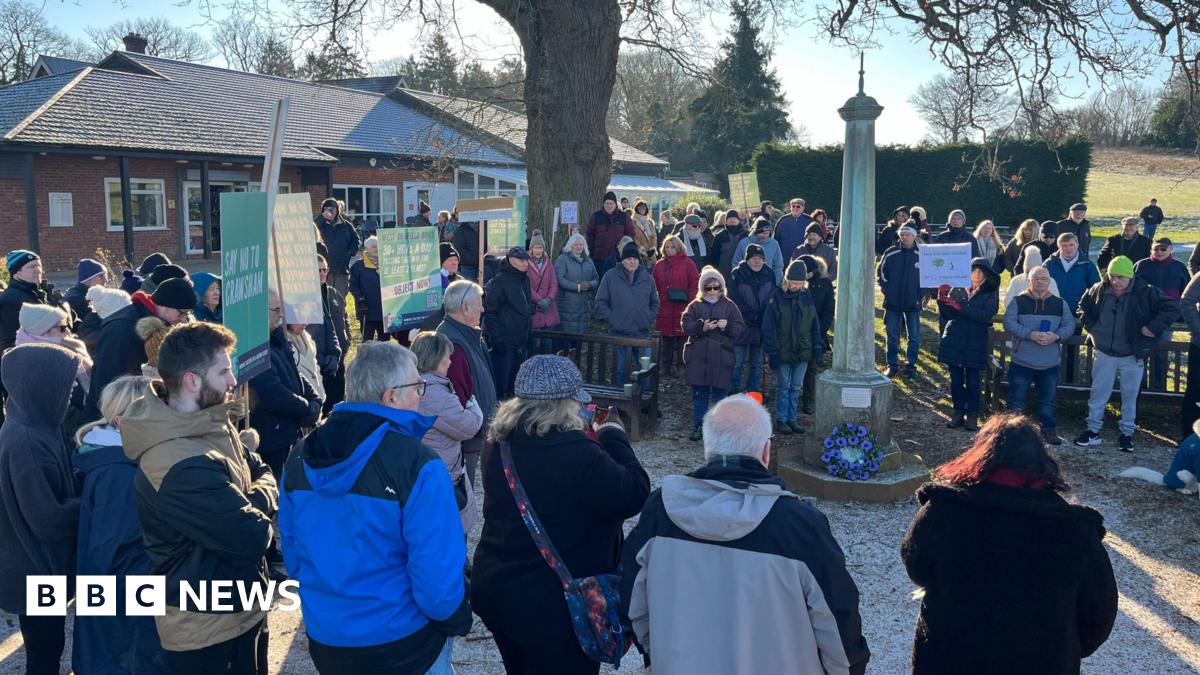 A group of people standing outside Ifield Golf Club as part of a protest against its proposed closure.