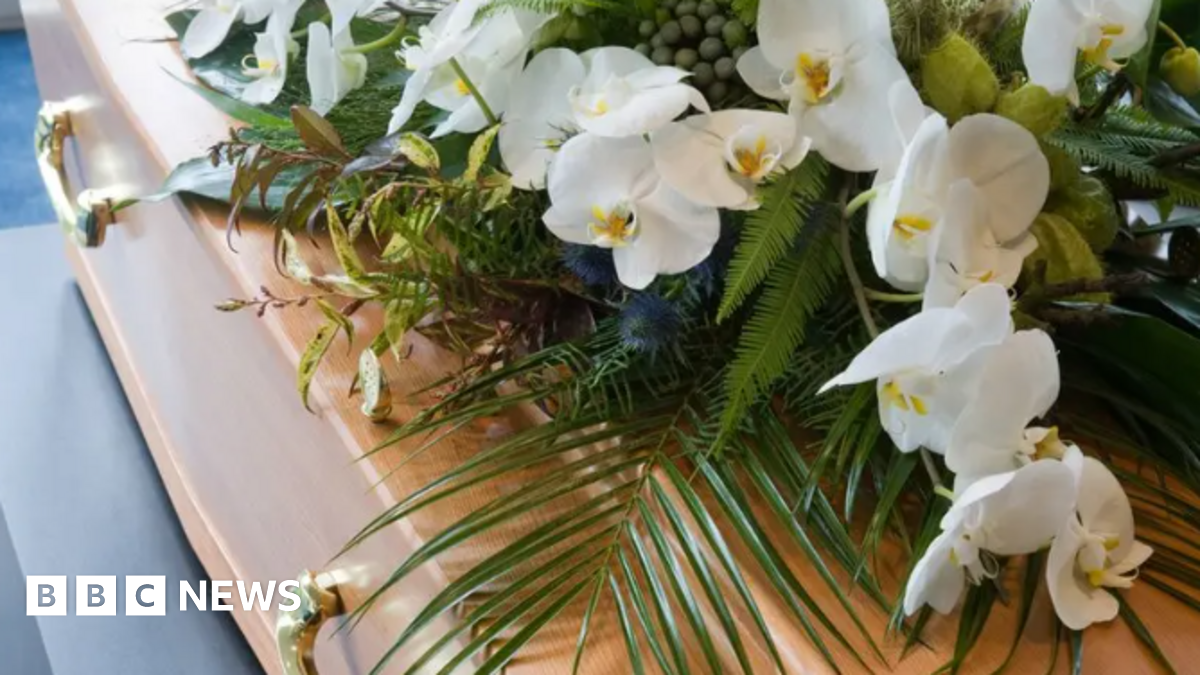 White flowers on a wooden coffin