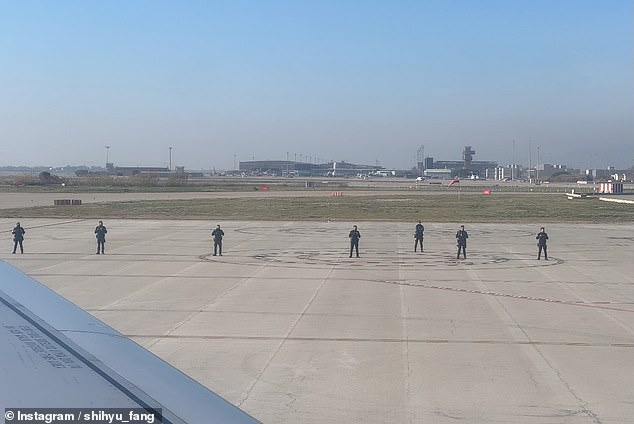Several apparently armed police officers were seen standing on the tarmac parallel to the plane