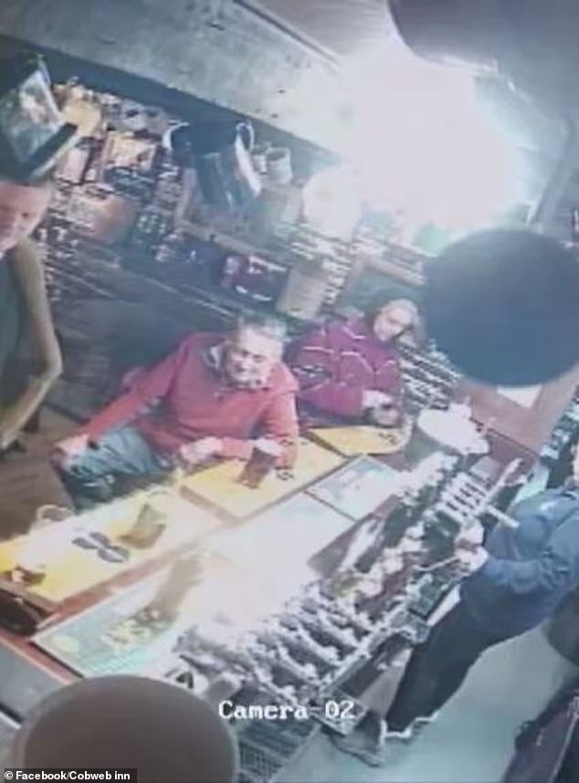 Key (behind), partner of Sir Mick Jagger's granddaughter, inside the pub in Boscastle earlier