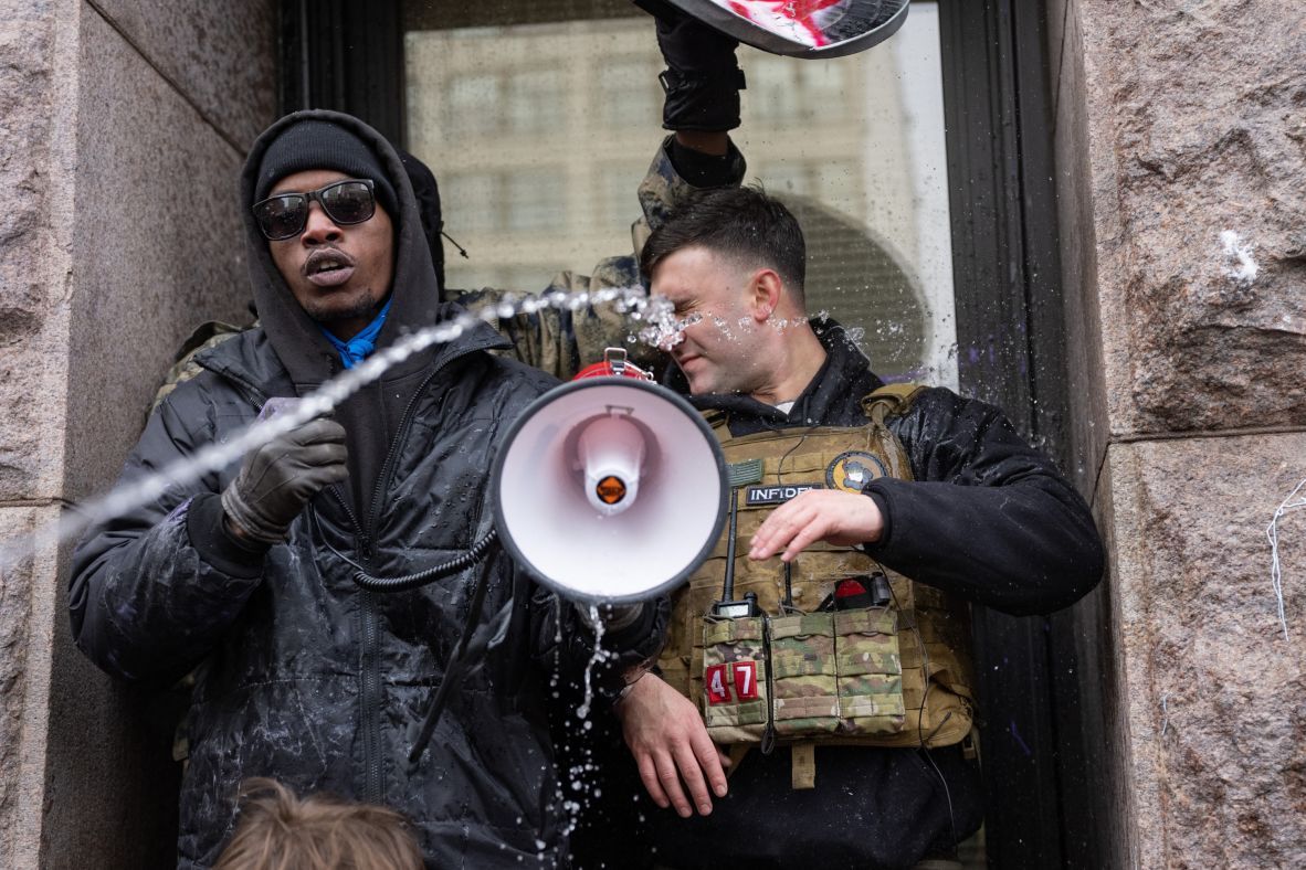 Jake Lang, a right-wing influencer, is sprayed with water by a protester outside Minneapolis City Hall on January 17. Lang's rally was cut short when <a href=