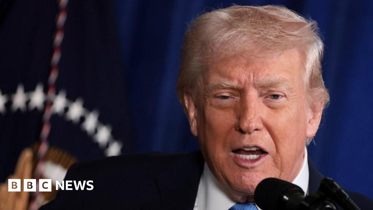 Venezuela's Vice-President Delcy Rodriguez presents the government's 2026 budget proposal to the National Assembly on 4 December 2025. She is wearing a salmon-coloured jacket and glasses. She is pointing with one hand and holding papers in the other.