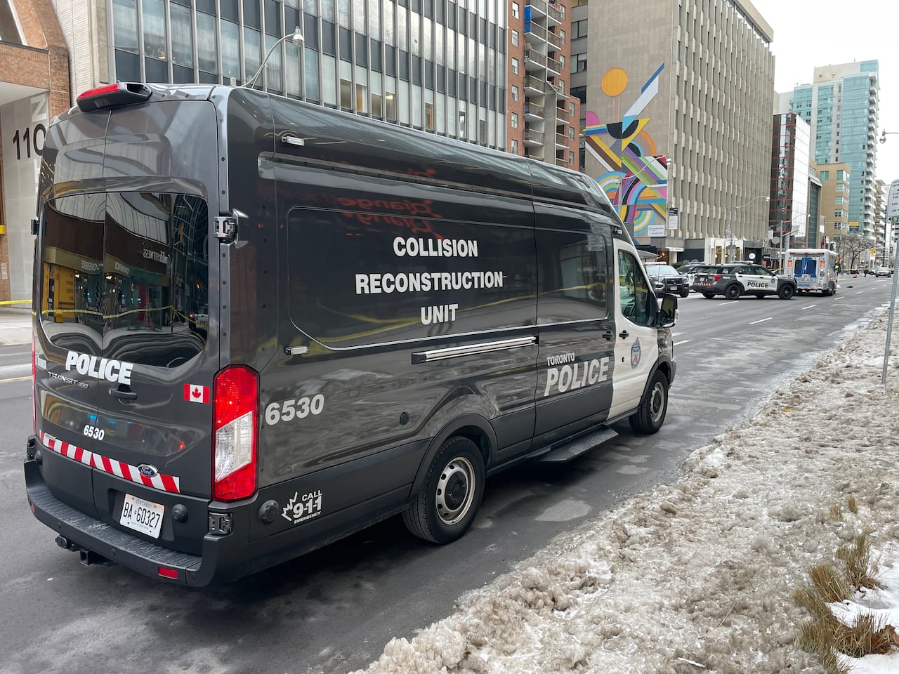 A black van is parked on a snowy street