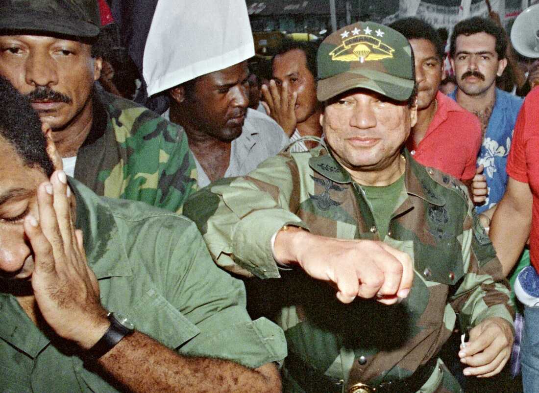 Panamian leader Gen. Manuel Antonio Noriega, right, fakes a punch to a supporter on May 2, 1989, at the laying of the foundation of a group home in the neighborhood of Panama City where boxer Roberto Duran was born.