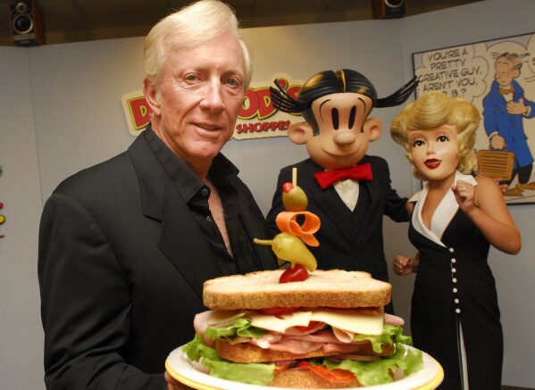 Dean Young shows off one a Dagwood sandwich at his New Orleans test kitchen Tuesday, May 9, 2006. (AP Photo/Cheryl Gerber, File)