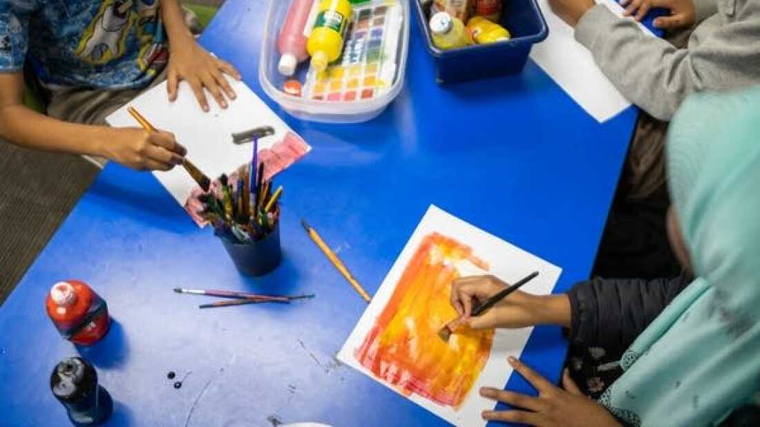 Children paint during an activity break at the ABC Learning Center in Minneapolis on Wednesday.