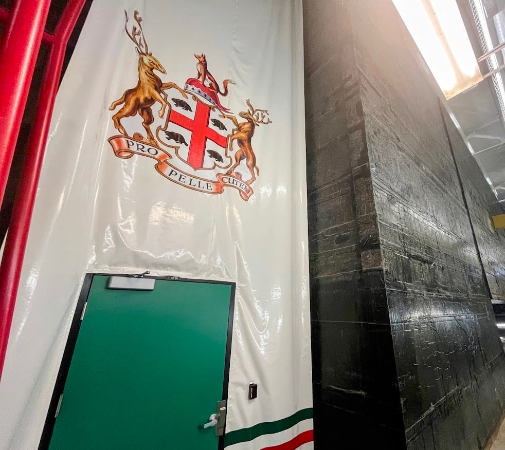 A crest above a door marks an entrance to a vault.