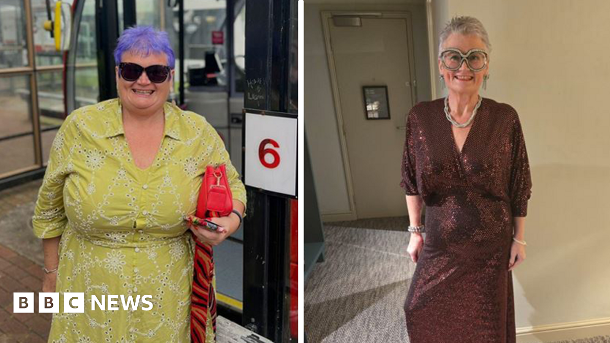 MP Carolyn Harris wearing a sparkling sequin maroon dress. She is standing  in what appears to be a hotel bedroom in front of the door and has on oversized, sparkly glasses. Carolyn is wearing a rope-style necklace and dangly earrings