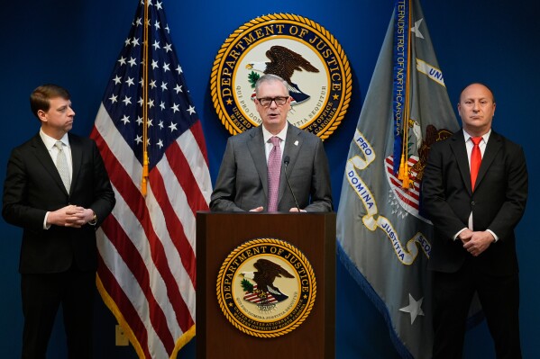 FBI Special Agent James C. Barnacle, Jr., center, U.S. Attorney for Western District of North Carolina Russ Ferguson, right, and Mint Hill Police Department Chief Joseph Hatley give a press conference, Friday, Jan. 2, 2026, in Charlotte, N.C. (AP Photo/Erik Verduzco)