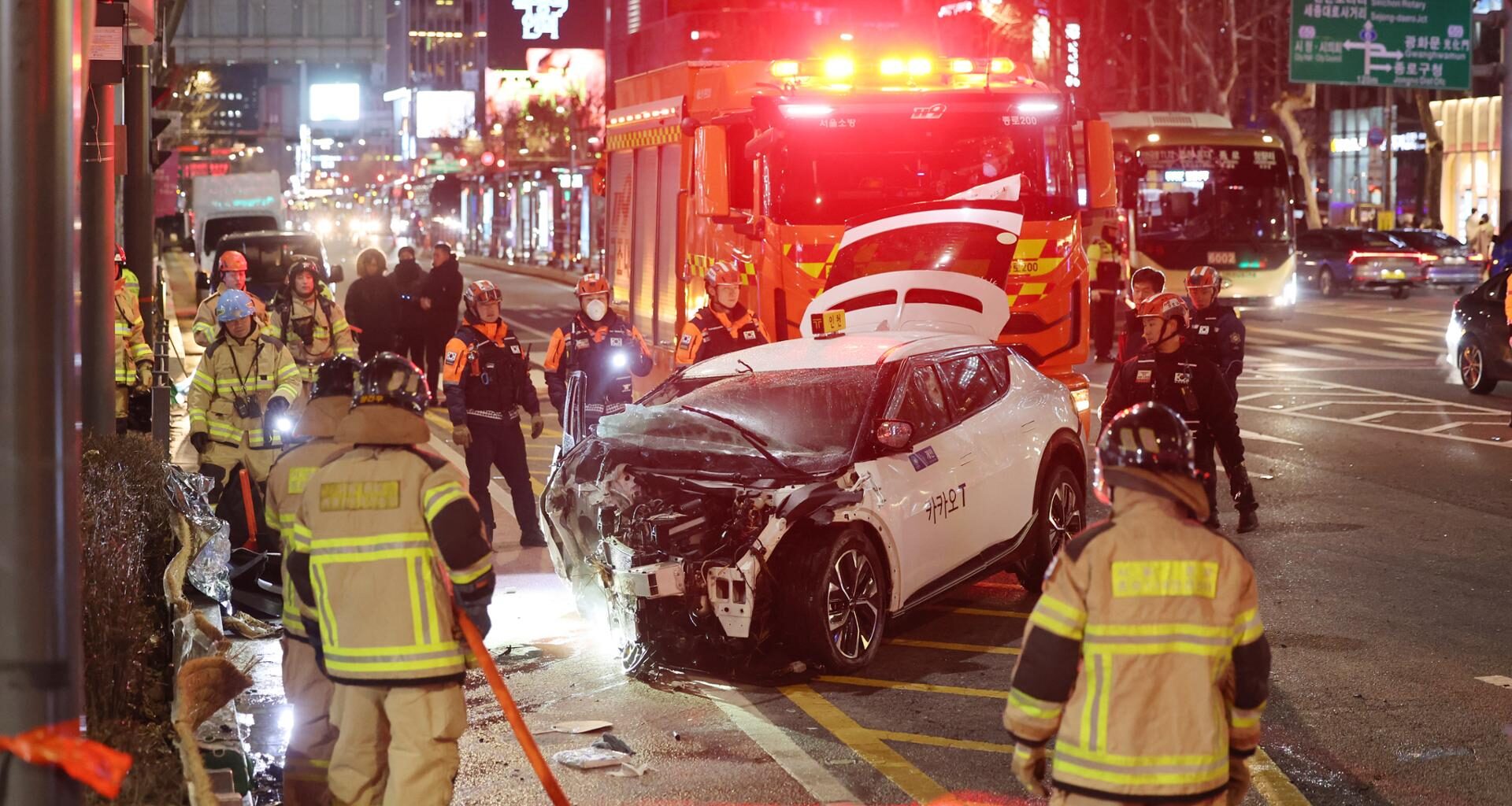 Firefighters inspect the site of a car crash near Jonggak Station in central Seoul, Friday, which killed one pedestrian. Yonhap