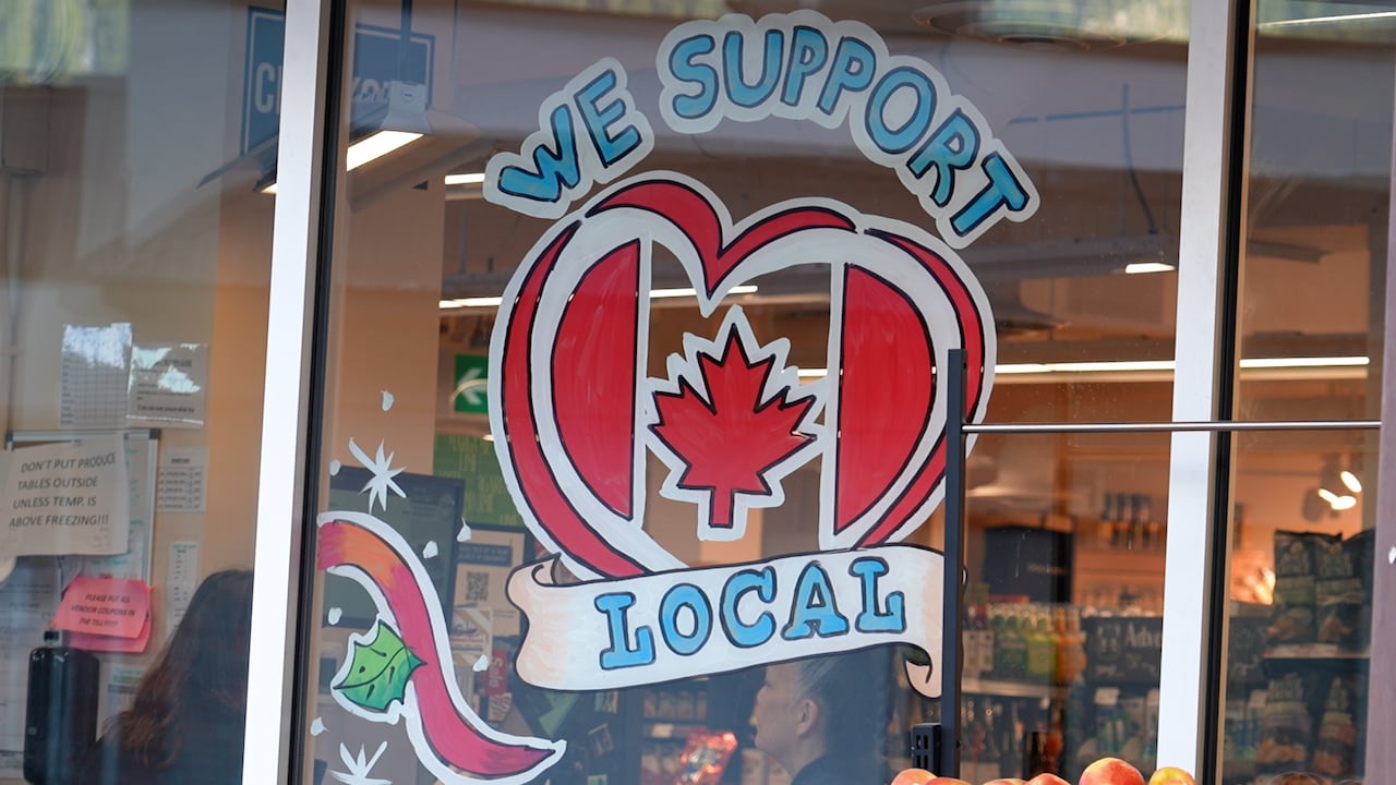 A sign on a grocery store that reads we support local 