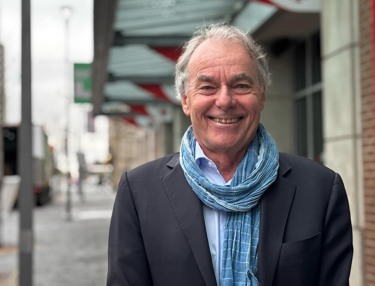 A man smiles at the camera