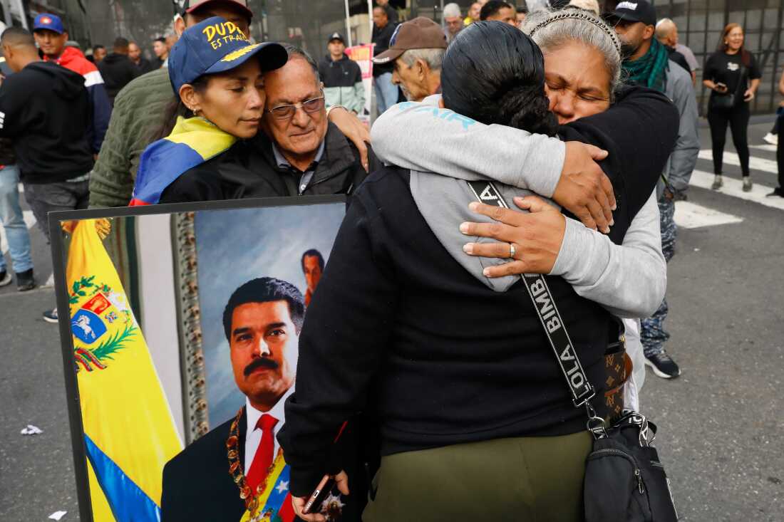 Supporters of Venezuelan President Nicolás Maduro embrace in downtown Caracas