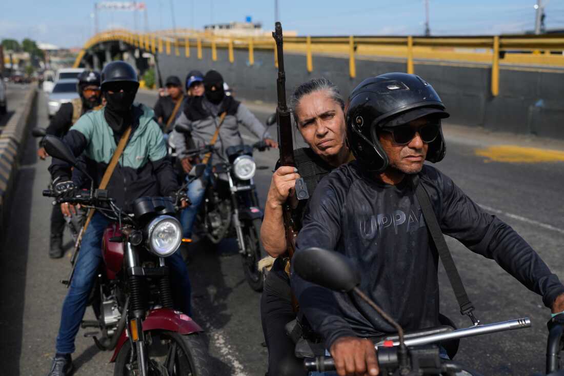 Pro-government armed civilians patrol in La Guaira, Venezuela, Saturday, Jan. 3, 2026, after U.S. President Donald Trump announced that President Nicolás Maduro had been captured and flown out of the country.