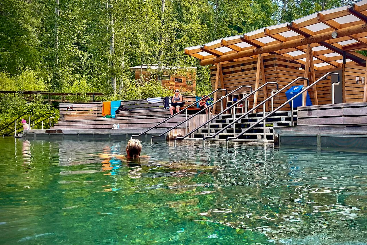 A bather relaxes in the natural pools of the Liard River Hot Springs