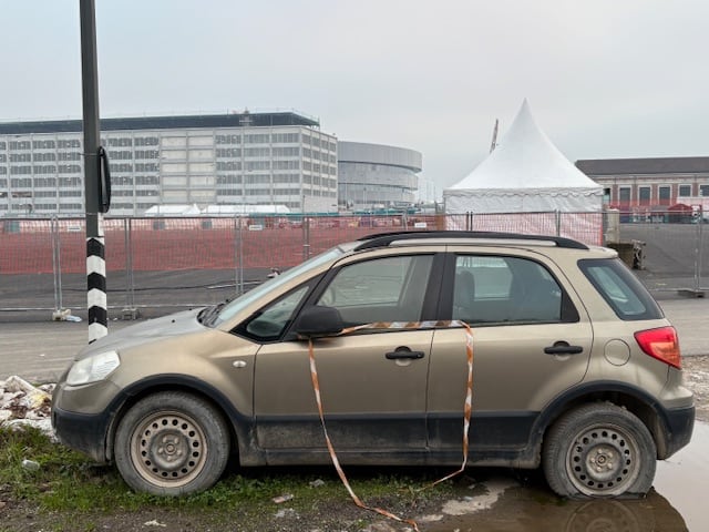 A car sits in a puddle.