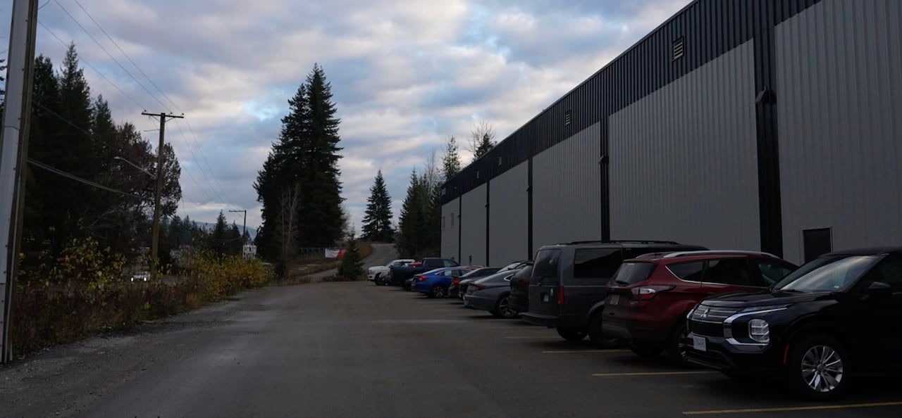 Vehicles parked in front of a warehouse 