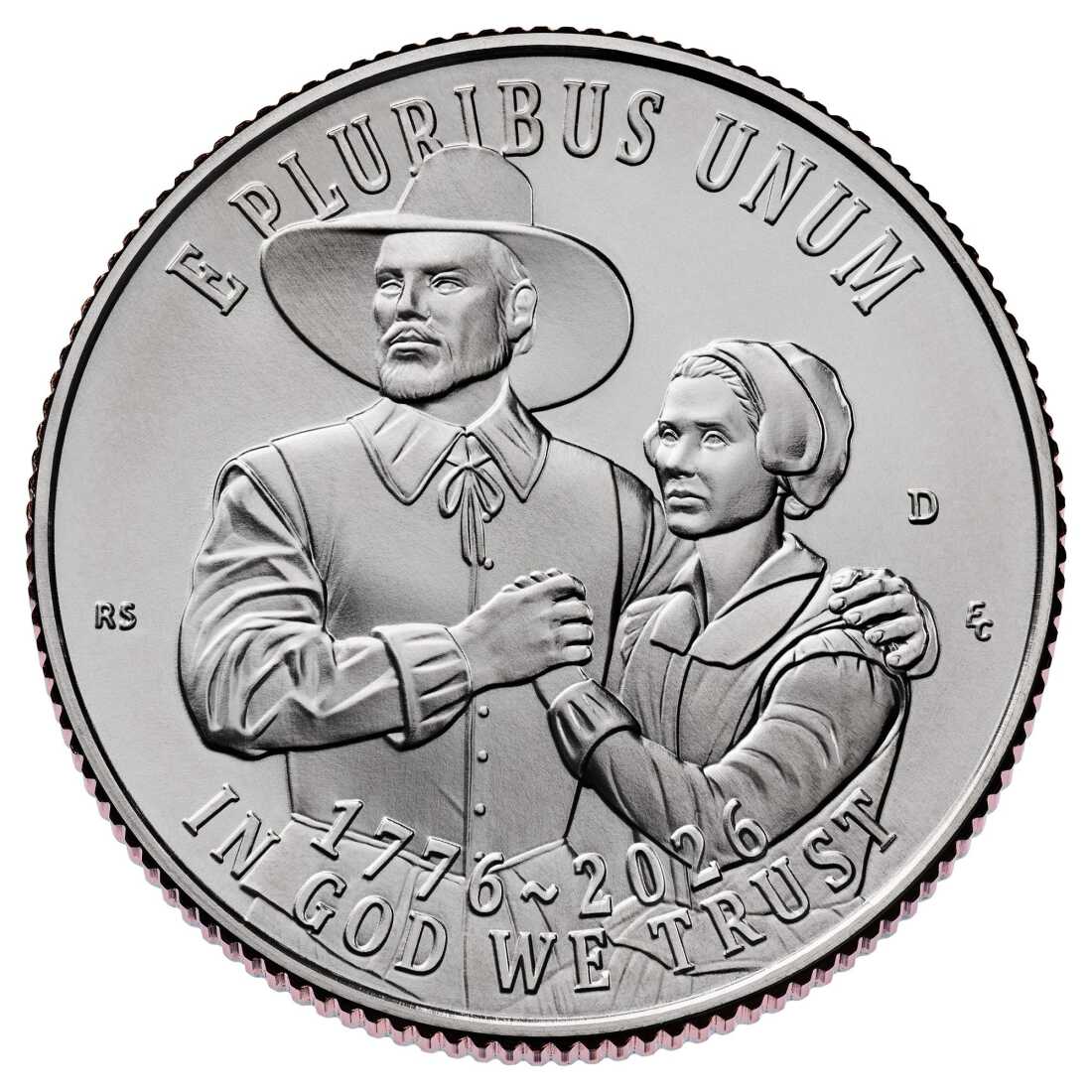 This photo shows one of the new anniversary quarters. A pilgrim man and woman are on the silver-colored coin. The words "E PLURIBUS UNUM" arch over the pilgrims, and the text "1776-2026" and "IN GOD WE TRUST" runs along the bottom edge.