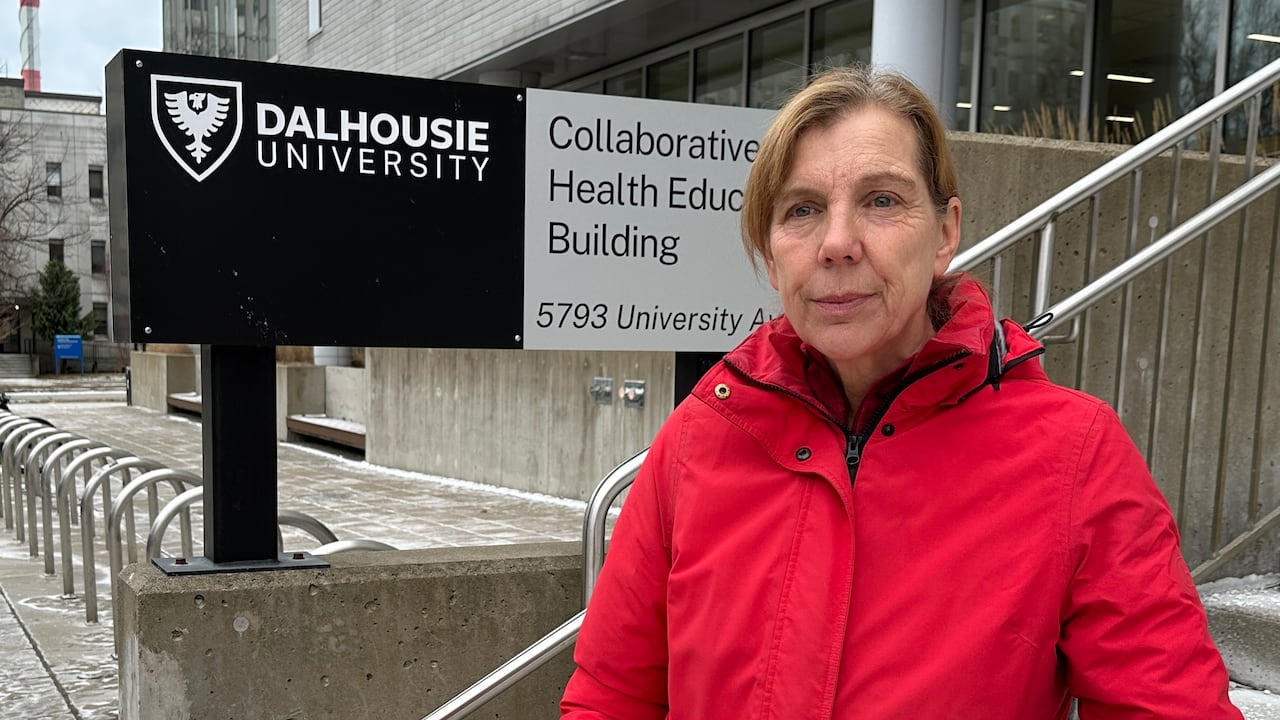 A woman is shown in a red jacket outside Dalhousie University in Halifax, N.S.