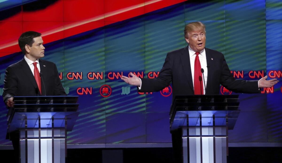 Donald Trump gestures during a 2016 presidential debate as Marco Rubio looks on