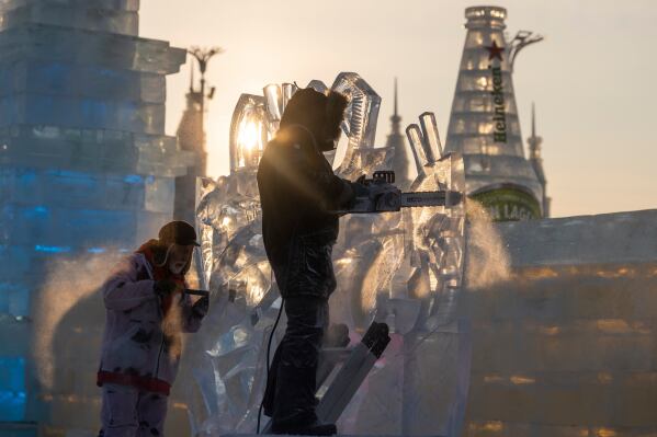 Ice sculptors prepare their works for competition in the annual Ice and Snow Festival held in Harbin in northeastern China's Heilongjiang province on Saturday, Jan. 3, 2026. (AP Photo/Ng Han Guan)