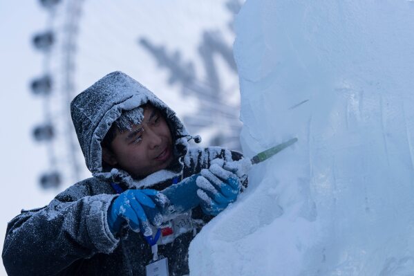 An ice sculptor prepares his work for competition in the annual Ice and Snow Festival held in Harbin in China's Heilongjiang province on Saturday, Jan. 3, 2026. (AP Photo/Ng Han Guan)